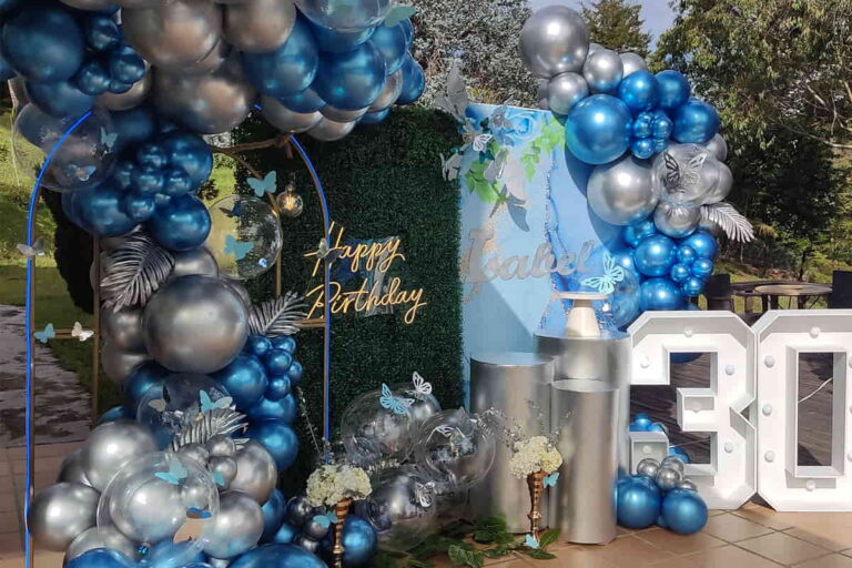 decoracion de cumpleaños con número mariposas y bombas azules con centro de mesa